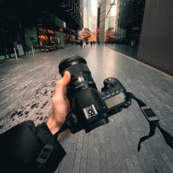 person holding black dslr camera