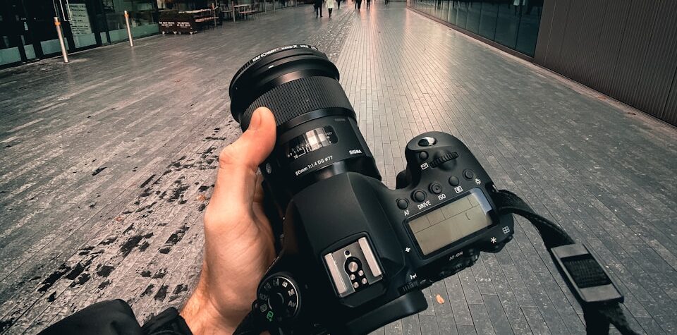 person holding black dslr camera